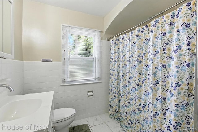 16842 Greenview Ave, Detroit, MI 48219 - bathroom with tile walls, vanity, a shower with curtain, a wainscoted wall, and marble finish flooring