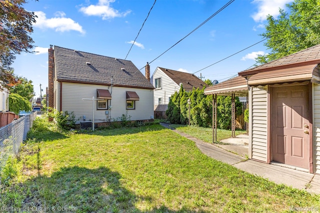 19163 Henry St, Melvindale, MI 48122 - back of house featuring a storage shed and a shingled roof