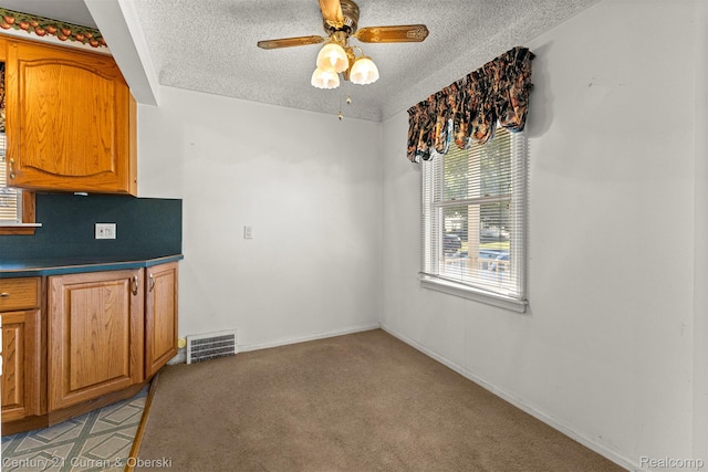 19163 Henry St, Melvindale, MI 48122 - unfurnished dining area with a textured ceiling, a ceiling fan, and light colored carpet