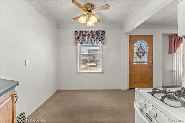 19163 Henry St, Melvindale, MI 48122 - entryway featuring a textured ceiling, plenty of natural light, ceiling fan, and light colored carpet