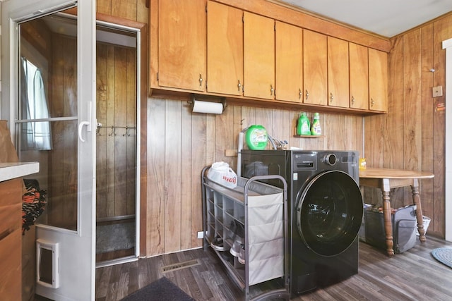 8698 Big Stone Lake Rd, Evart, MI 49631 - washroom featuring dark wood-type flooring, washer / dryer, wooden walls, and cabinet space