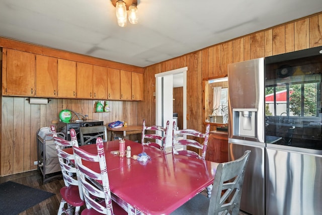 8698 Big Stone Lake Rd, Evart, MI 49631 - dining space featuring wood walls and dark wood-style floors