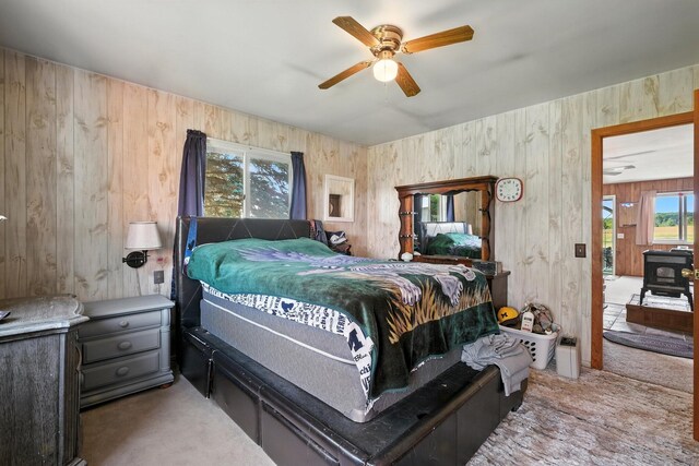 8698 Big Stone Lake Rd, Evart, MI 49631 - bedroom with wood walls, carpet flooring, and ceiling fan