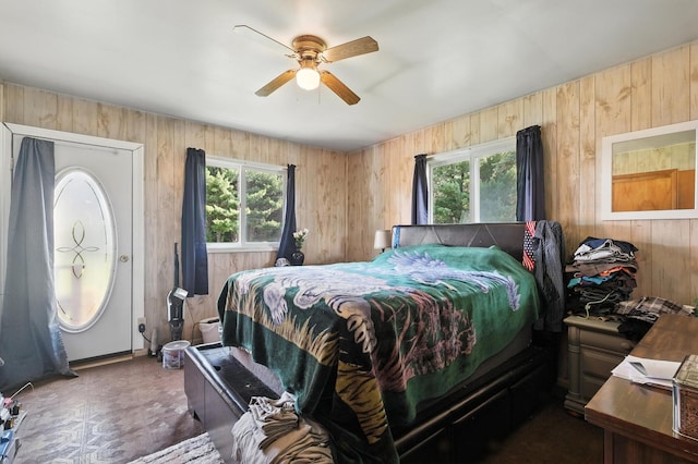 8698 Big Stone Lake Rd, Evart, MI 49631 - bedroom with multiple windows, wooden walls, and a ceiling fan
