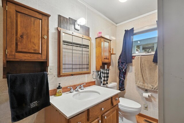 8698 Big Stone Lake Rd, Evart, MI 49631 - bathroom with tile walls, vanity, decorative backsplash, and ornamental molding