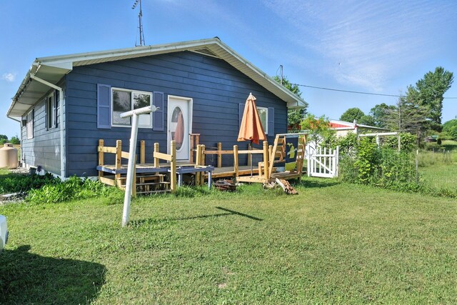 8698 Big Stone Lake Rd, Evart, MI 49631 - back of property featuring a yard and a wooden deck