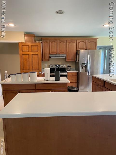 24890 Arden Park Dr, Farmington Hills, MI 48336 - kitchen with electric range oven, stainless steel fridge with ice dispenser, under cabinet range hood, a kitchen island, and light countertops
