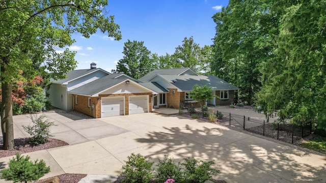 15665 Portage Rd, Vicksburg, MI 49097 - view of front facade featuring an attached garage, brick siding, and driveway