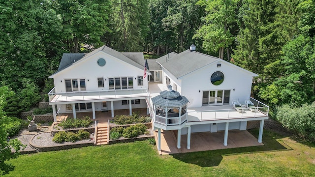 15665 Portage Rd, Vicksburg, MI 49097 - rear view of property featuring stairs, a lawn, french doors, a patio, and a view of trees