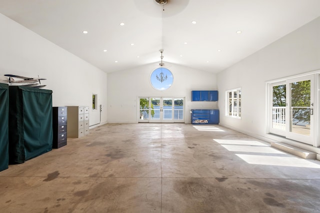 15665 Portage Rd, Vicksburg, MI 49097 - unfurnished living room featuring high vaulted ceiling, concrete floors, french doors, and recessed lighting