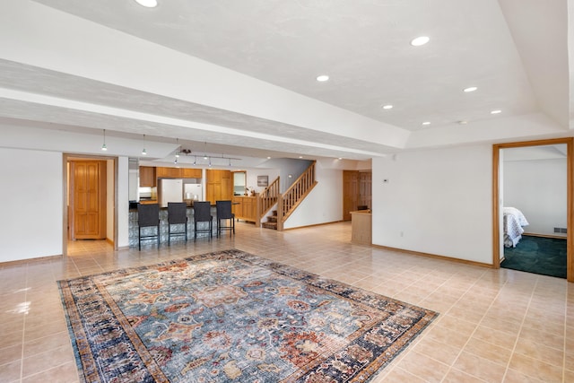 15665 Portage Rd, Vicksburg, MI 49097 - living area with light tile patterned flooring, stairs, a tray ceiling, and recessed lighting