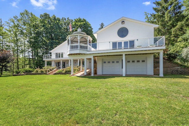 15665 Portage Rd, Vicksburg, MI 49097 - view of front facade with an attached garage, a balcony, a front yard, and a gazebo