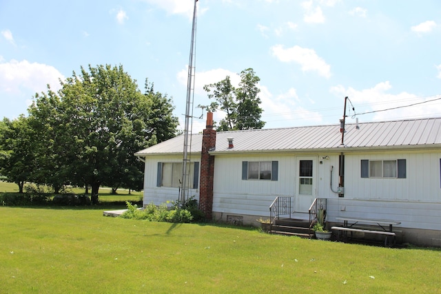 2786 Dinius Rd, Tecumseh, MI 49286 - rear view of property featuring a yard and a metal roof