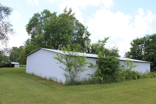 2786 Dinius Rd, Tecumseh, MI 49286 - view of side of property featuring an outbuilding, an outdoor structure, and a lawn