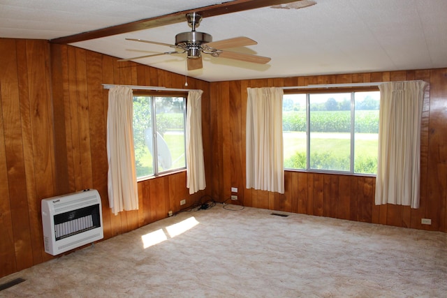2786 Dinius Rd, Tecumseh, MI 49286 - spare room with heating unit, a ceiling fan, wooden walls, and carpet floors