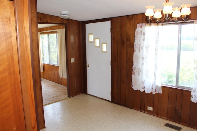2786 Dinius Rd, Tecumseh, MI 49286 - entrance foyer featuring a chandelier and wooden walls