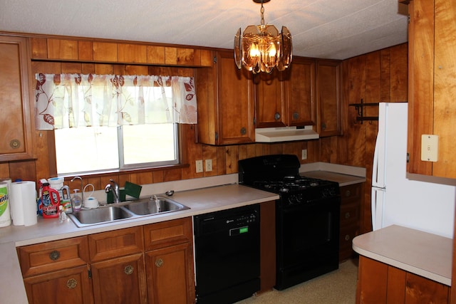 2786 Dinius Rd, Tecumseh, MI 49286 - kitchen with black appliances, under cabinet range hood, brown cabinets, light countertops, and wood walls