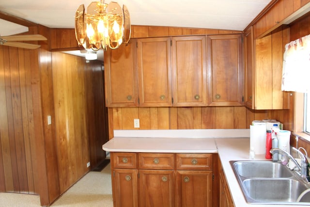 2786 Dinius Rd, Tecumseh, MI 49286 - kitchen featuring brown cabinetry, light countertops, wood walls, a chandelier, and decorative light fixtures