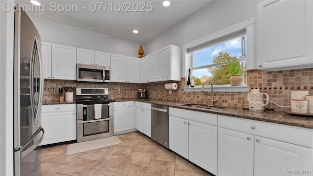 3230 Lynhurst Ct, Rochester, MI 48306 - kitchen with stainless steel appliances, white cabinetry, decorative backsplash, dark stone countertops, and recessed lighting