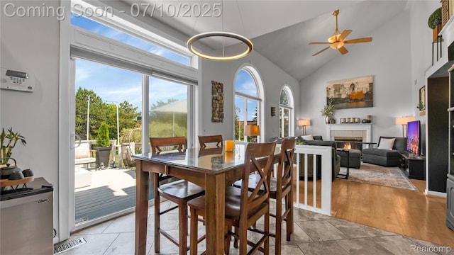 3230 Lynhurst Ct, Rochester, MI 48306 - dining area with high vaulted ceiling, a ceiling fan, and a fireplace