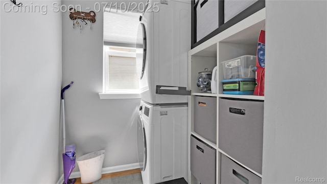 3230 Lynhurst Ct, Rochester, MI 48306 - washroom with estacked washer and dryer and baseboards