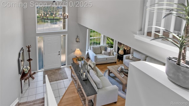 3230 Lynhurst Ct, Rochester, MI 48306 - living room with a high ceiling, a chandelier, and tile patterned floors