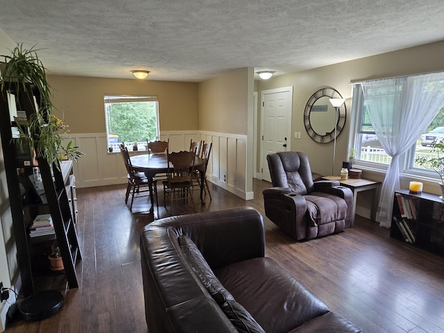 3330 Bradford St NE, Grand Rapids, MI 49525 - living area with a textured ceiling, hardwood / wood-style floors, a wainscoted wall, and a decorative wall