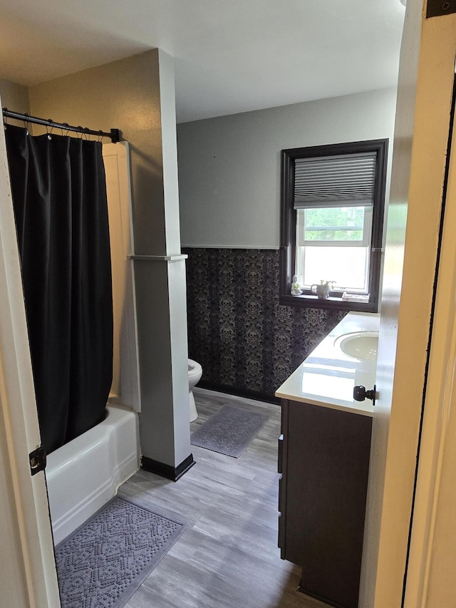 3330 Bradford St NE, Grand Rapids, MI 49525 - full bathroom featuring vanity, wood finished floors, wainscoting, and shower / bath combo with shower curtain