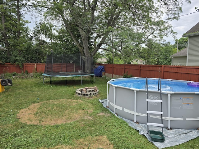 3330 Bradford St NE, Grand Rapids, MI 49525 - fenced backyard with a trampoline