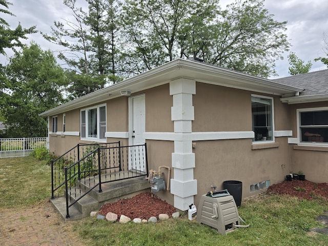 3330 Bradford St NE, Grand Rapids, MI 49525 - view of home's exterior featuring stucco siding and roof with shingles
