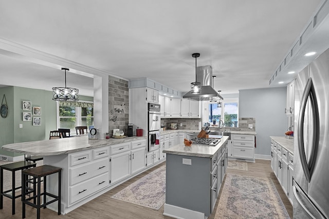 11560 Thrush Dr, Lakeview, MI 48850 - kitchen with appliances with stainless steel finishes, a peninsula, white cabinetry, backsplash, and recessed lighting