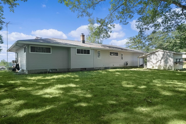 11560 Thrush Dr, Lakeview, MI 48850 - rear view of house featuring a chimney and a yard