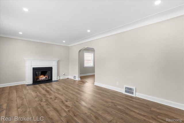 10320 Roxbury St, Detroit, MI 48224 - unfurnished living room with arched walkways, wood finished floors, a fireplace with flush hearth, recessed lighting, and ornamental molding