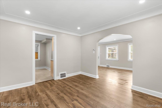 10320 Roxbury St, Detroit, MI 48224 - empty room featuring arched walkways, wood finished floors, recessed lighting, and ornamental molding