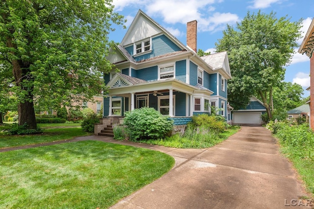 305 W Chicago Blvd, Tecumseh, MI 49286 - view of front of home featuring a chimney, covered porch, a garage, and a front lawn