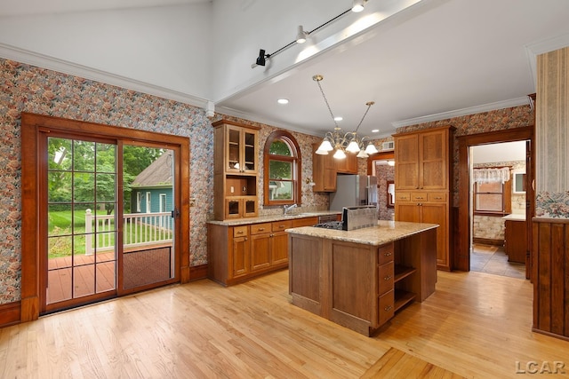 305 W Chicago Blvd, Tecumseh, MI 49286 - kitchen featuring open shelves, freestanding refrigerator, brown cabinets, wallpapered walls, and light wood-style floors