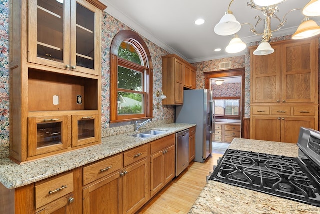 305 W Chicago Blvd, Tecumseh, MI 49286 - kitchen featuring appliances with stainless steel finishes, wallpapered walls, ornamental molding, healthy amount of natural light, and light wood-style flooring