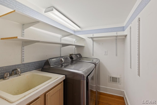 305 W Chicago Blvd, Tecumseh, MI 49286 - laundry area with separate washer and dryer and wood finished floors