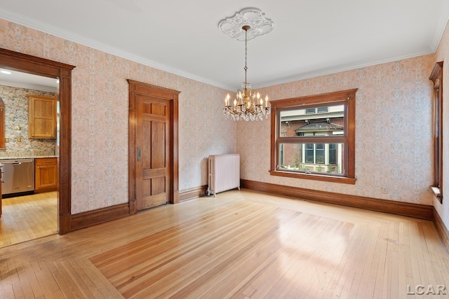 305 W Chicago Blvd, Tecumseh, MI 49286 - spare room with radiator heating unit, light wood-style flooring, a chandelier, wallpapered walls, and ornamental molding