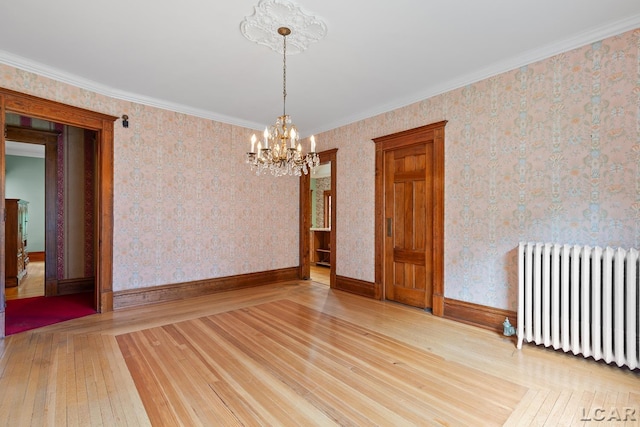 305 W Chicago Blvd, Tecumseh, MI 49286 - spare room with radiator heating unit, a chandelier, wood-type flooring, and ornamental molding