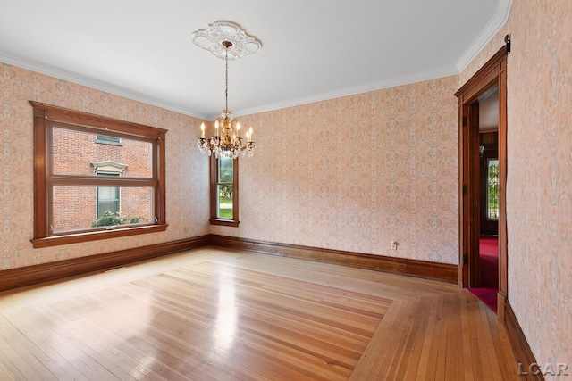 305 W Chicago Blvd, Tecumseh, MI 49286 - spare room featuring a chandelier, wood-type flooring, and ornamental molding