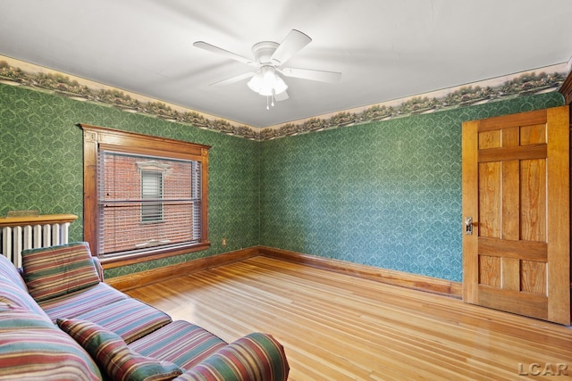 305 W Chicago Blvd, Tecumseh, MI 49286 - living room with wood finished floors, wallpapered walls, and a ceiling fan