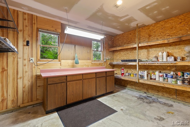 305 W Chicago Blvd, Tecumseh, MI 49286 - misc room with unfinished concrete floors and wood walls