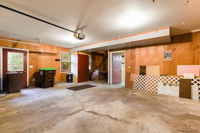 305 W Chicago Blvd, Tecumseh, MI 49286 - garage featuring wood walls and a garage door opener