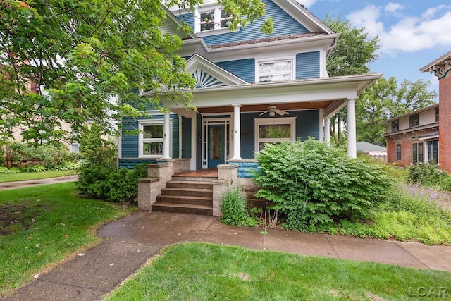 305 W Chicago Blvd, Tecumseh, MI 49286 - american foursquare style home featuring a porch, a front yard, and ceiling fan