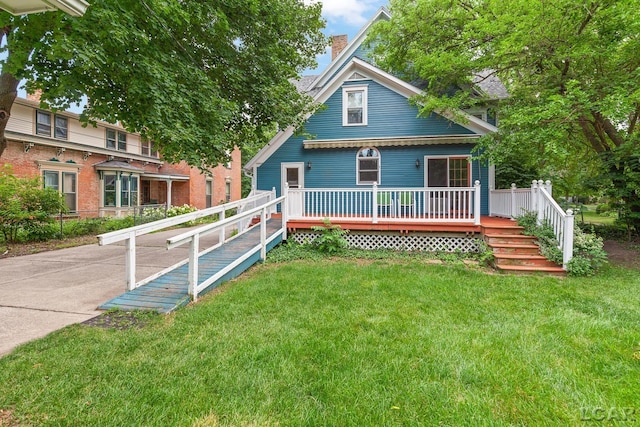 305 W Chicago Blvd, Tecumseh, MI 49286 - victorian house featuring a chimney, a front yard, and a wooden deck