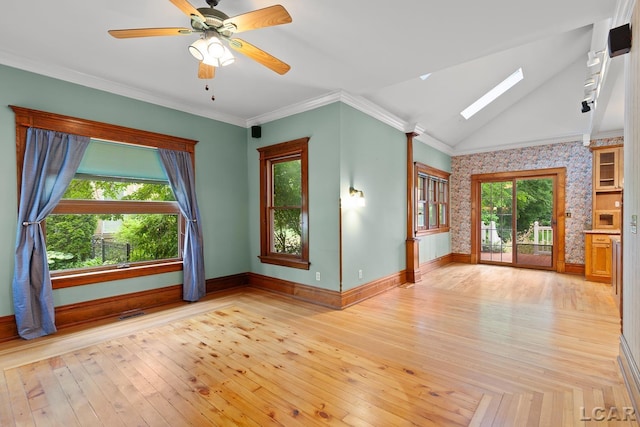 305 W Chicago Blvd, Tecumseh, MI 49286 - empty room featuring a skylight, wallpapered walls, light wood-style floors, lofted ceiling, and a ceiling fan