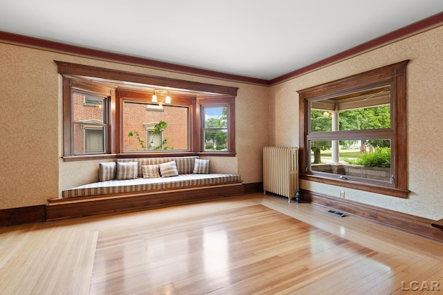 305 W Chicago Blvd, Tecumseh, MI 49286 - empty room with radiator heating unit, hardwood / wood-style flooring, and ornamental molding