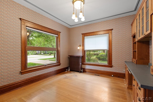 305 W Chicago Blvd, Tecumseh, MI 49286 - unfurnished office with light wood-type flooring, a chandelier, radiator, and wallpapered walls