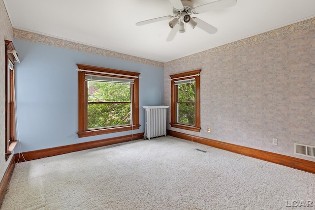 305 W Chicago Blvd, Tecumseh, MI 49286 - carpeted empty room featuring radiator heating unit, ceiling fan, and wallpapered walls